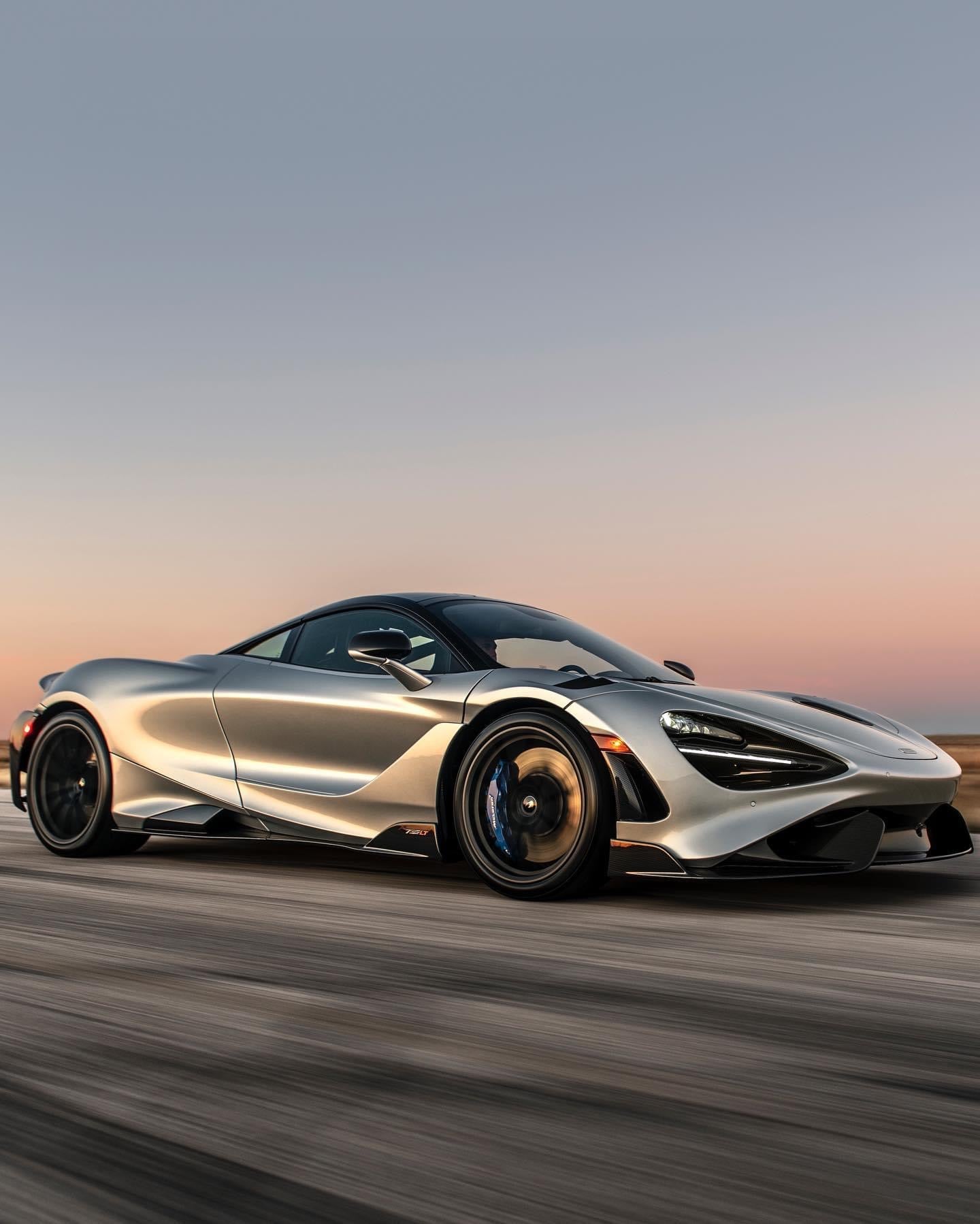 Silver sports car on a blurred road with a sunset background detailing by Liquid Tec